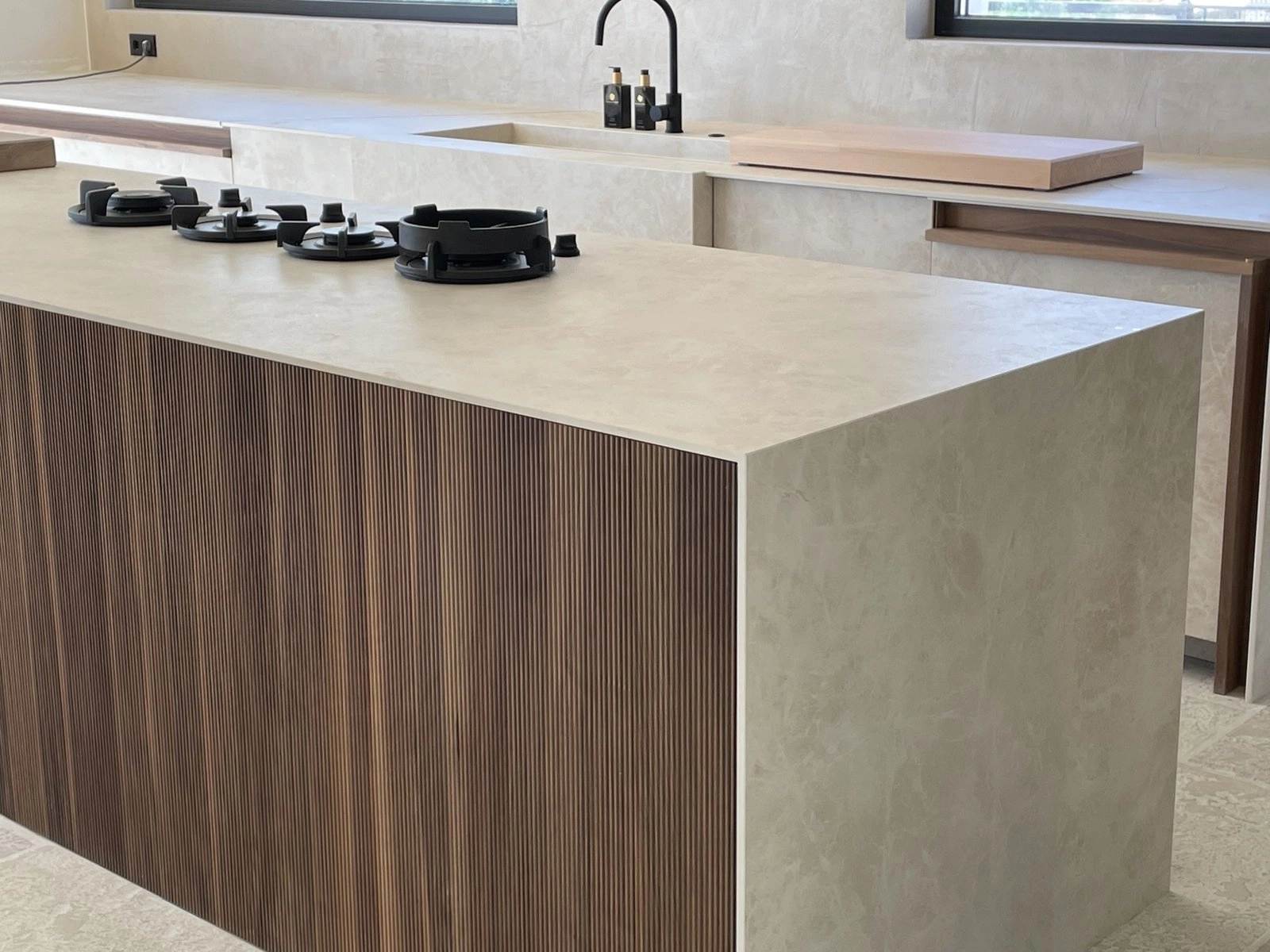 Kitchen island in walnut and stone