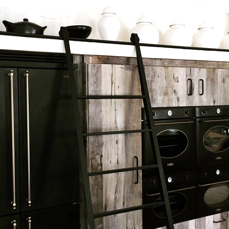 Kitchen with timber cabinets and a library ladder